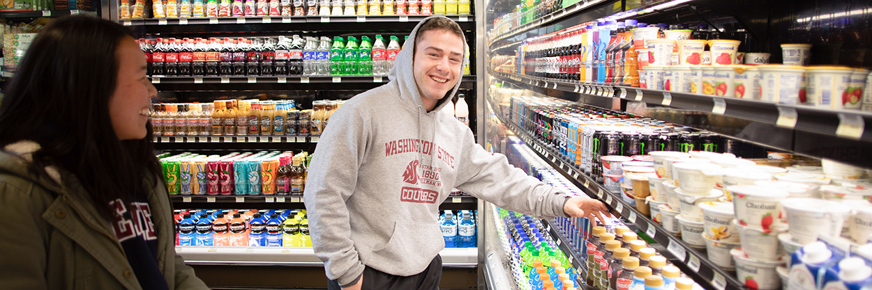 A person grabbing a drink from the cooler.