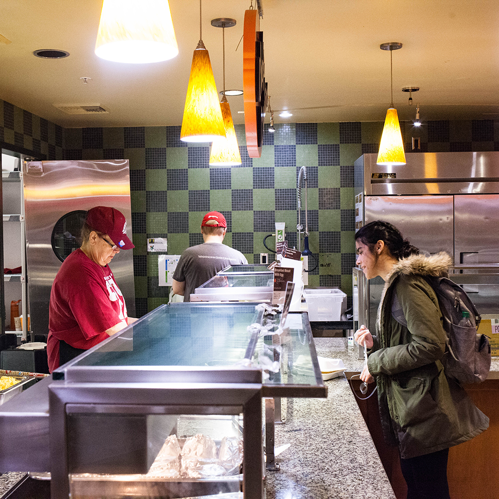 A student getting food from the Chef's Creation station.